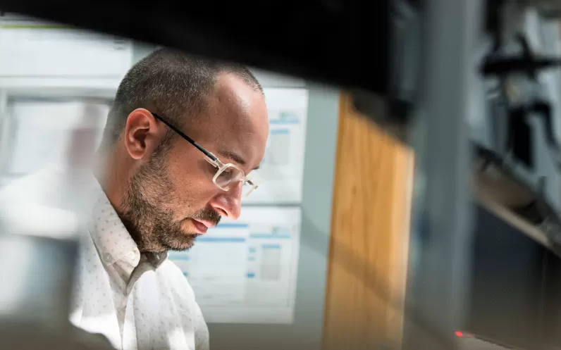 Image showing a man looking down at work in an office