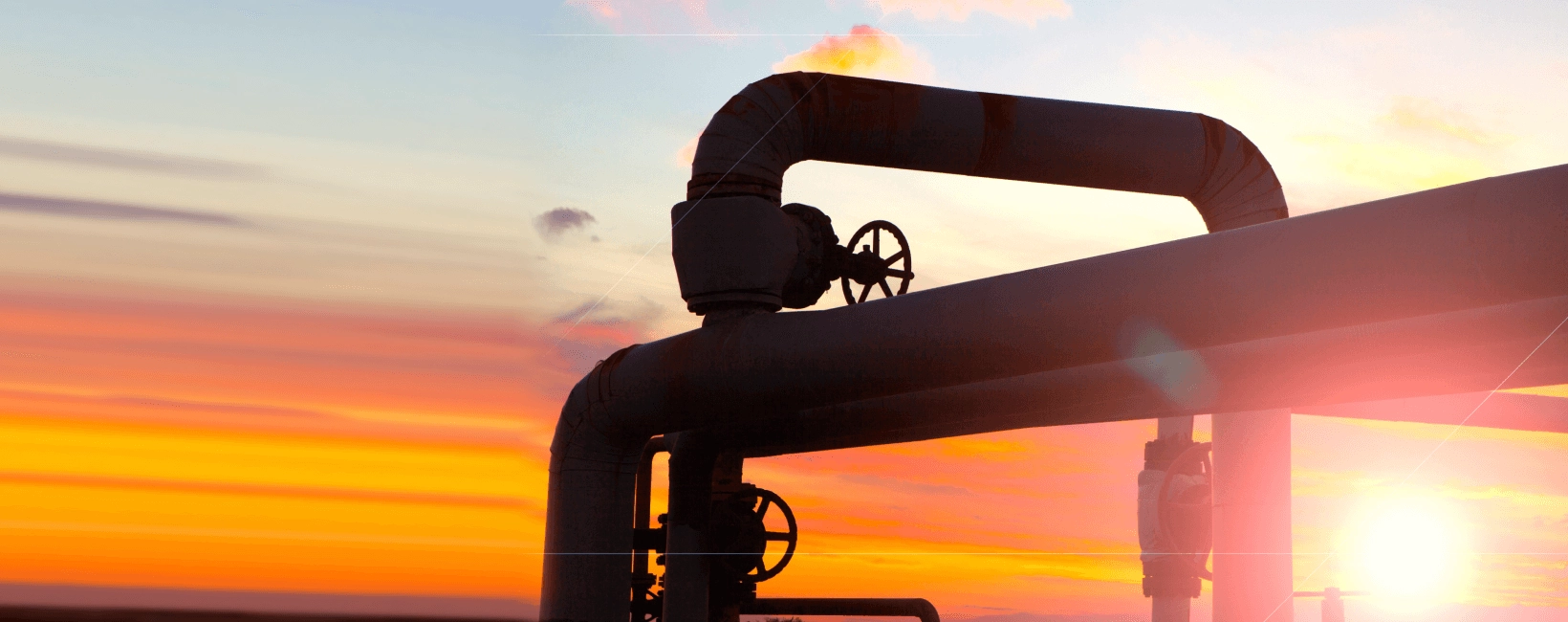 Image showing two gas pipes against a sunset