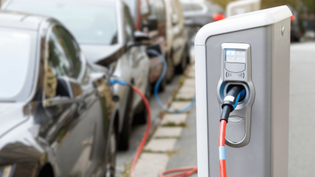 Electric car plugged into charging station