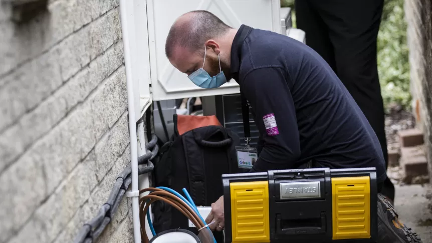 Kneeling down to install a smart meter during covid