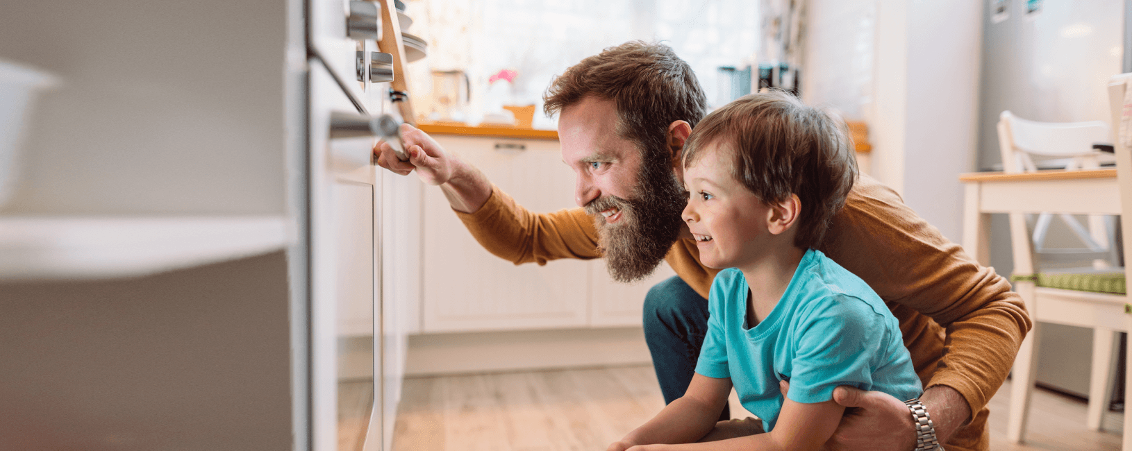 Man and child looking in an oven