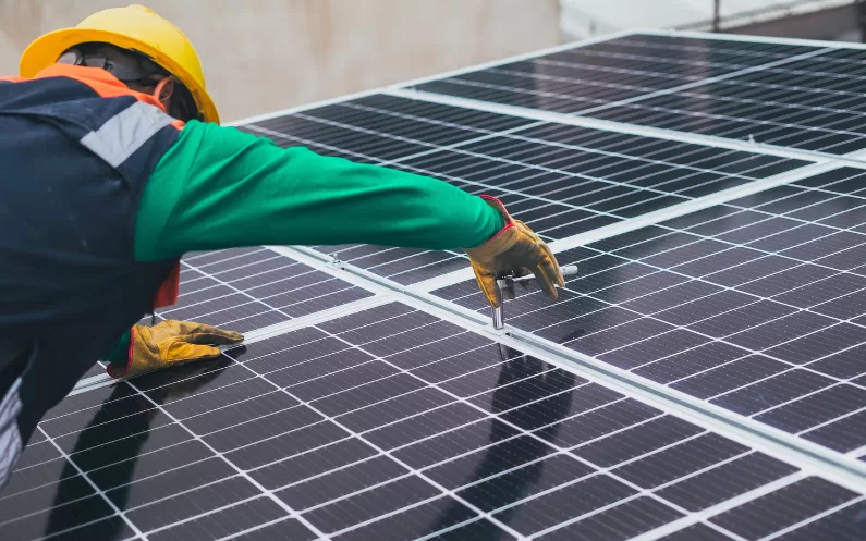 Image showing a worker fitting a solar panel