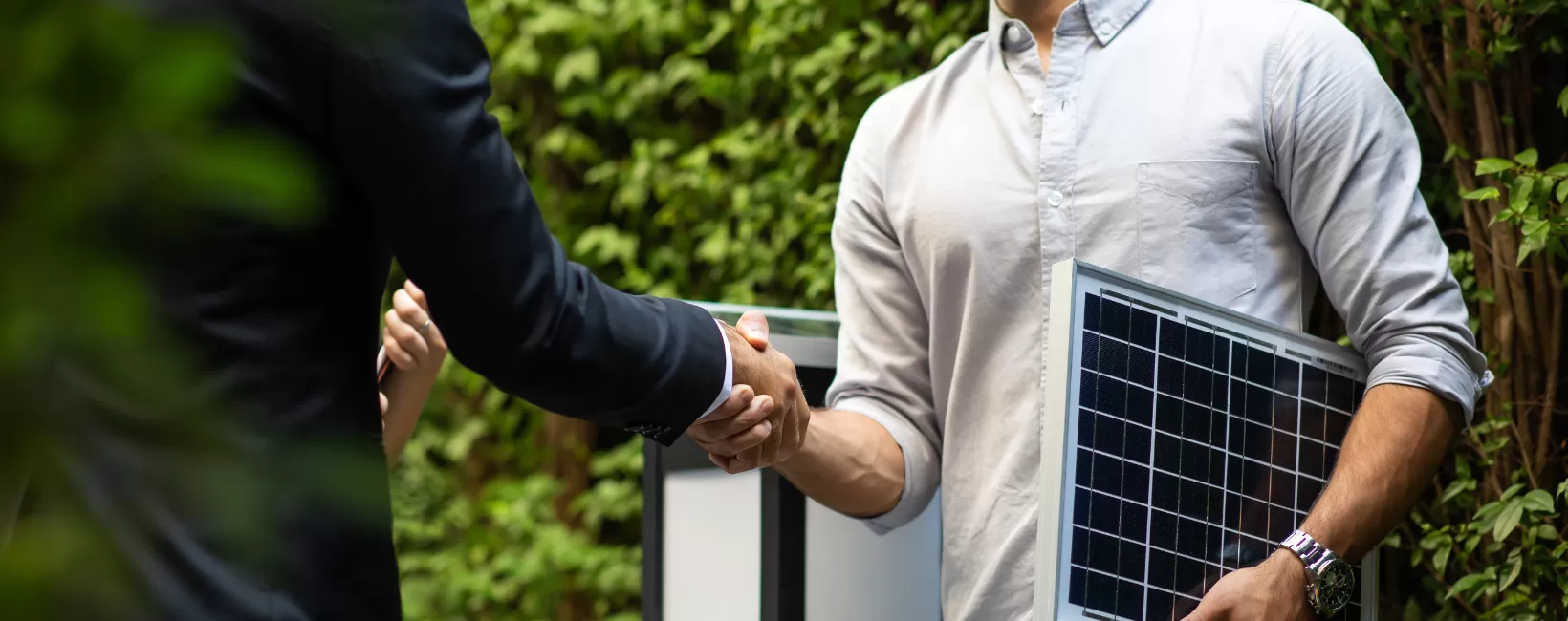 energy consultant shakes hands with client